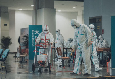 A group of people in hazmat suits deep cleaning a waiting room